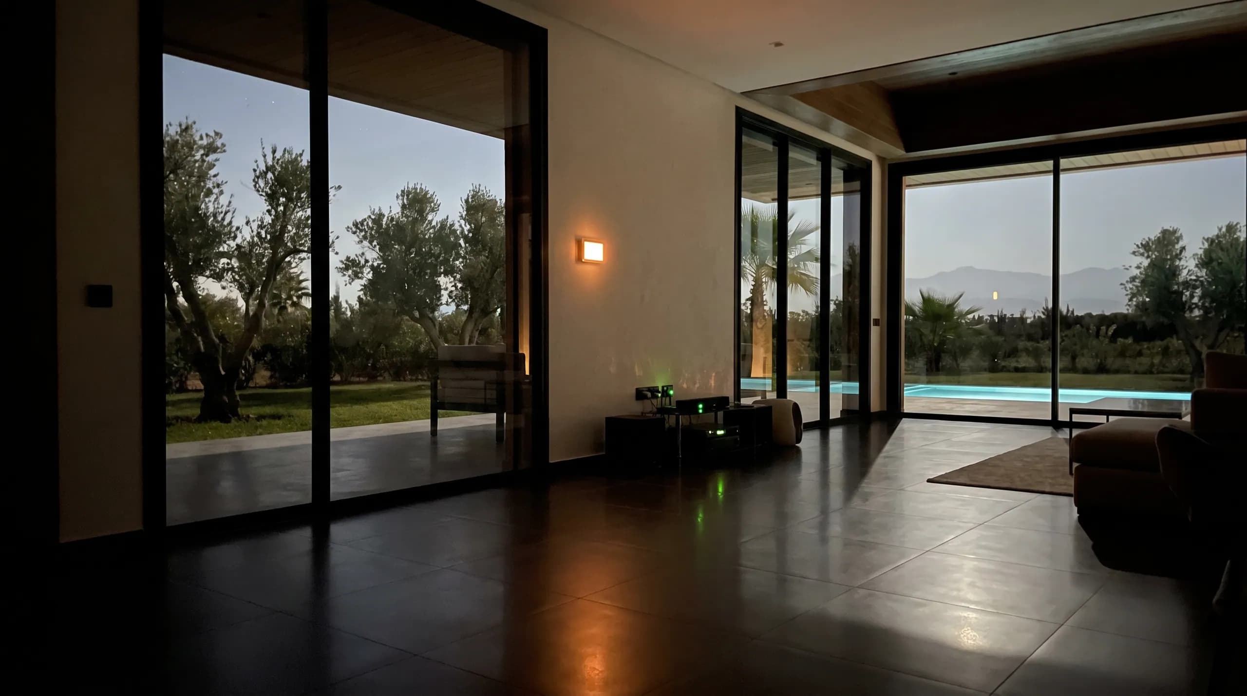 The villa interior at night — thermostat glow, tiny green status lights, order